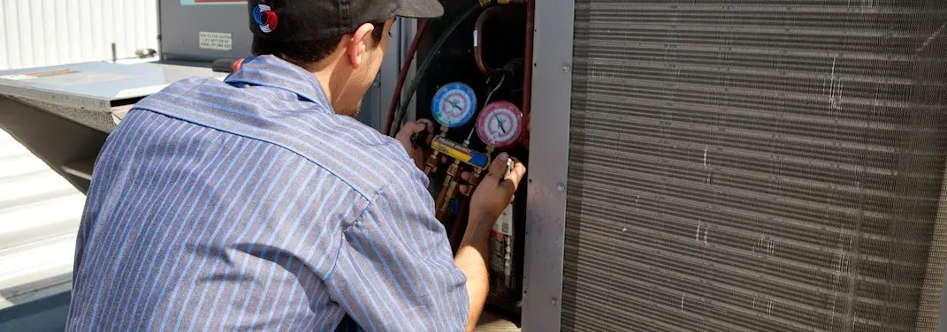HVAC technician servicing a condenser unit in South Patrick Shores